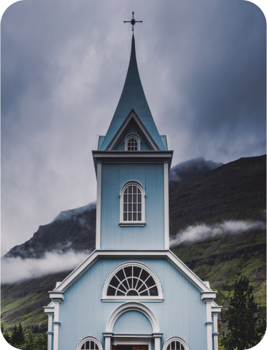 old church with clouds and fog in background