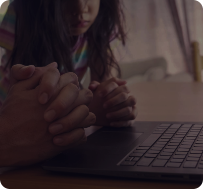 Two people praying. One of them is a woman.