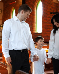 Family holding hands exiting traditional church sanctuary